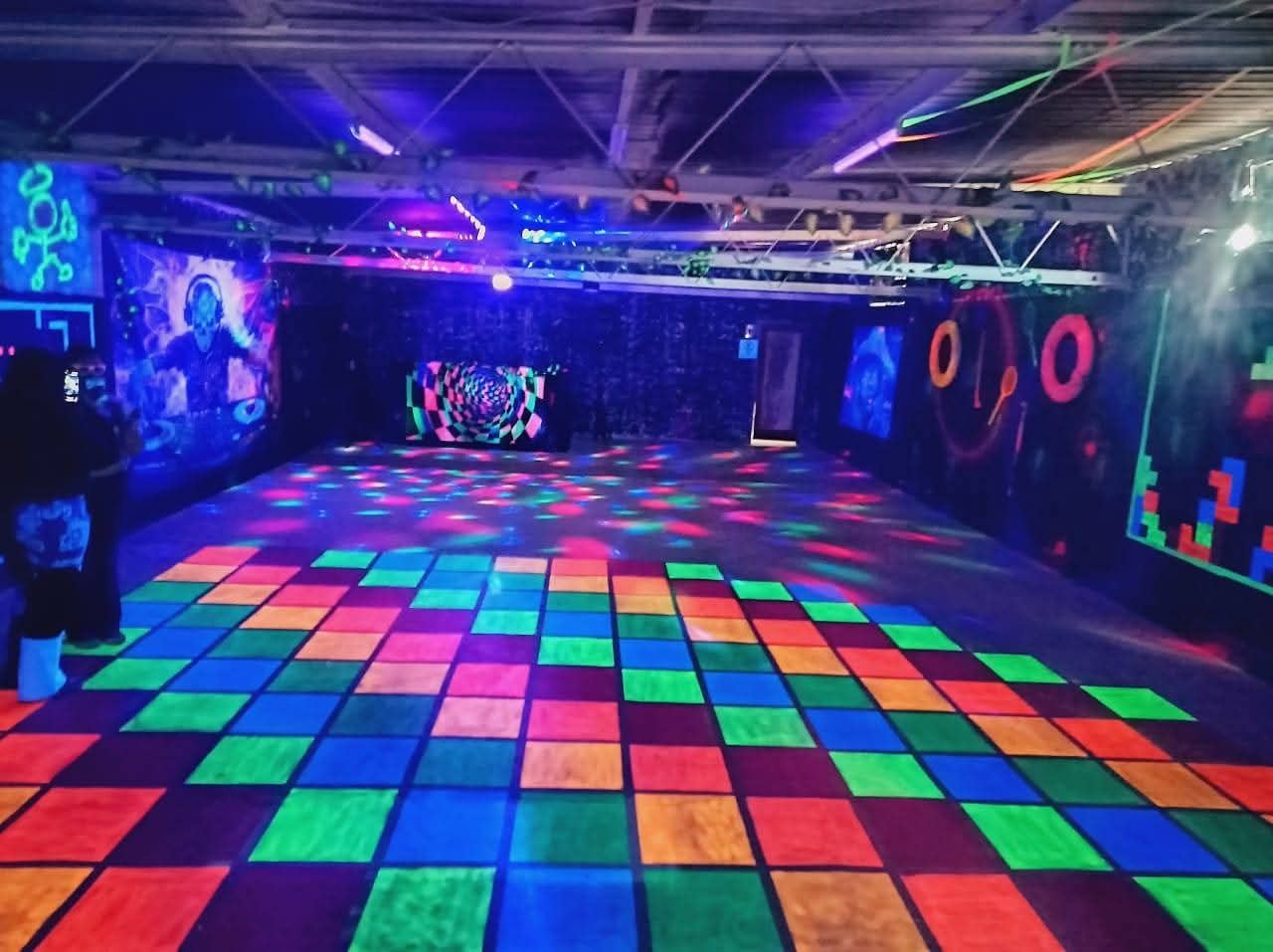 Light-up 80s disco dance floor with neon murals