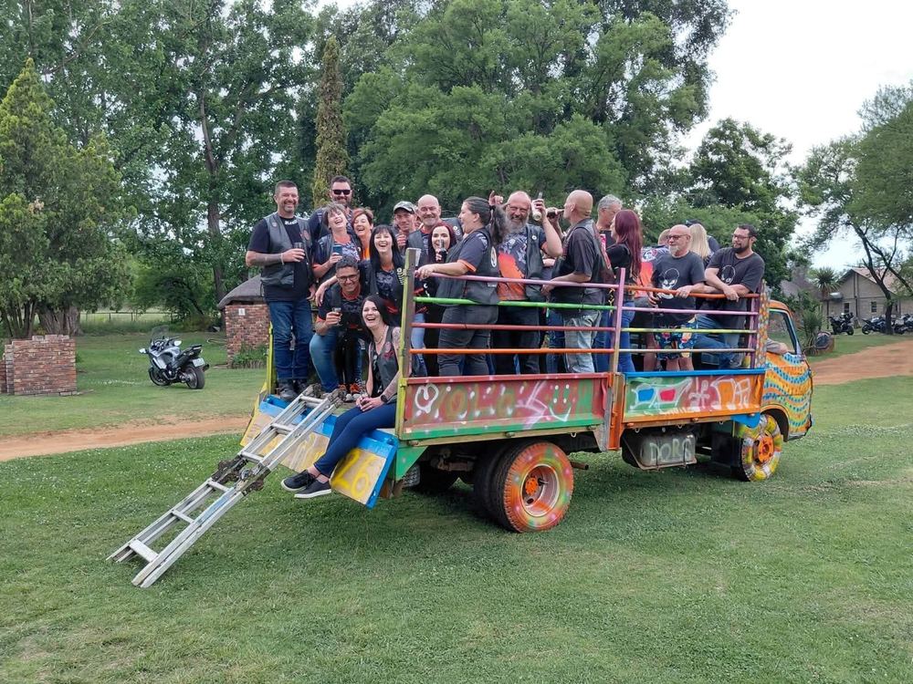 Group celebrating on the back of a painted party truck
